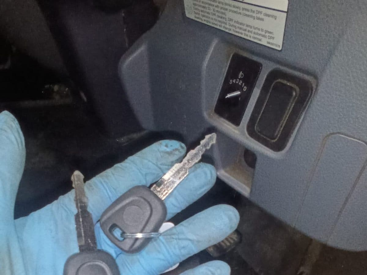 Replacement truck keys held beside a cab ignition during an all-keys-lost job